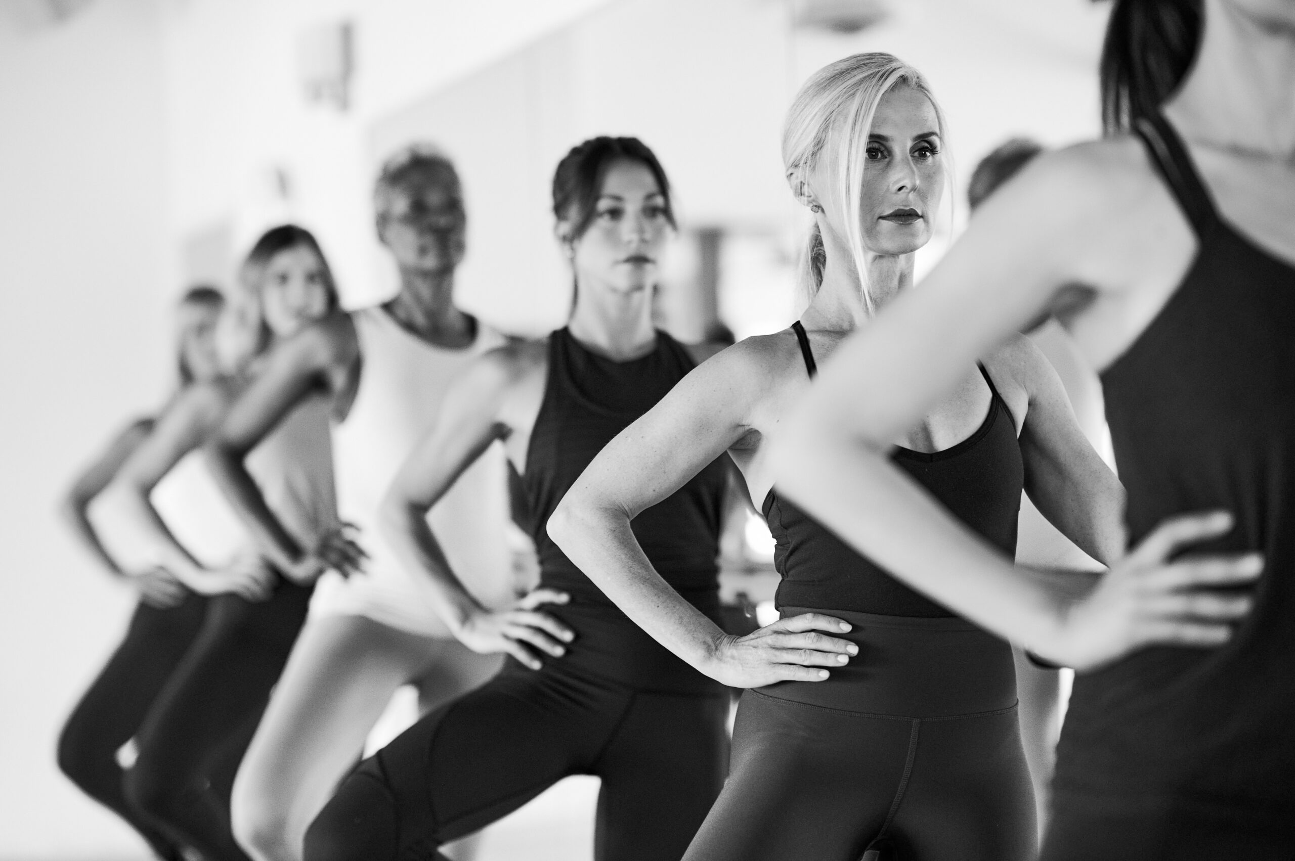 Black and white photo of women in a line at the barre
